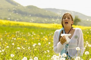 Woman-sneezing-with-tissue-in-meadow-779344